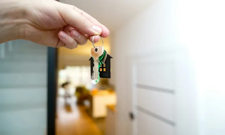 A person holding apartment keys